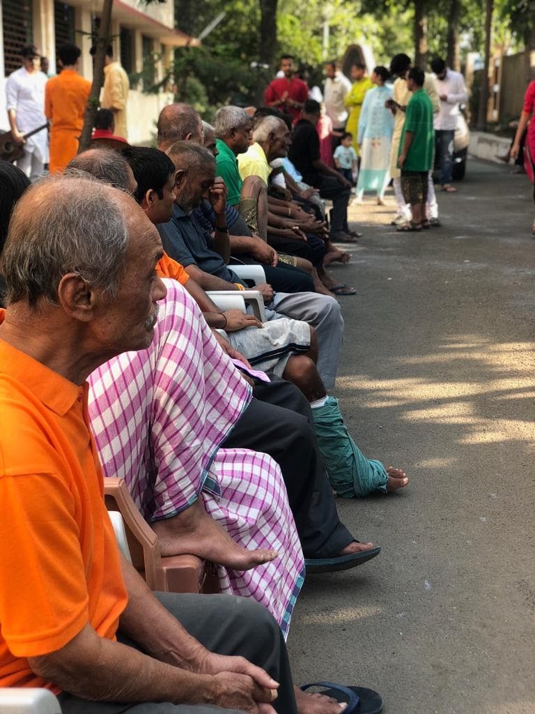 Row of elderly residents seated outdoors, 2018
